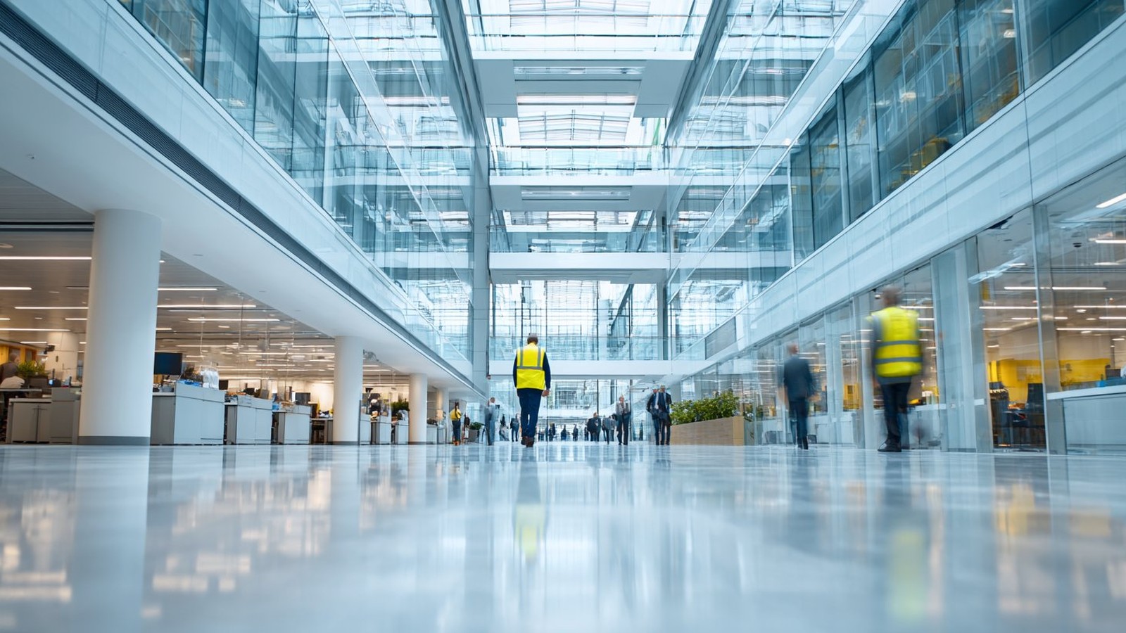 CHS facility technician walking through modern corporate office atrium — Adelaide