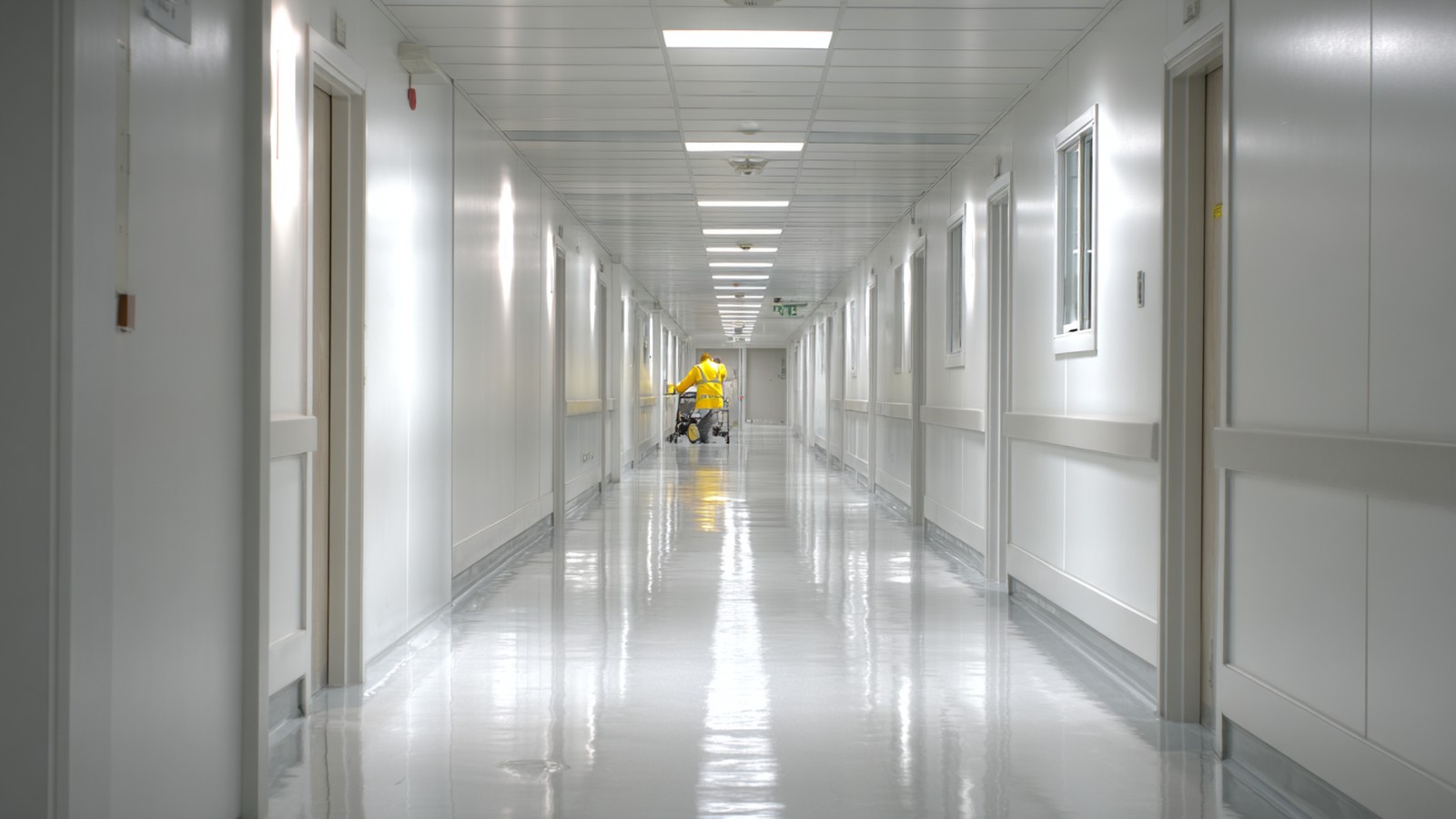 CHS facility technician in clinical hospital corridor — Adelaide